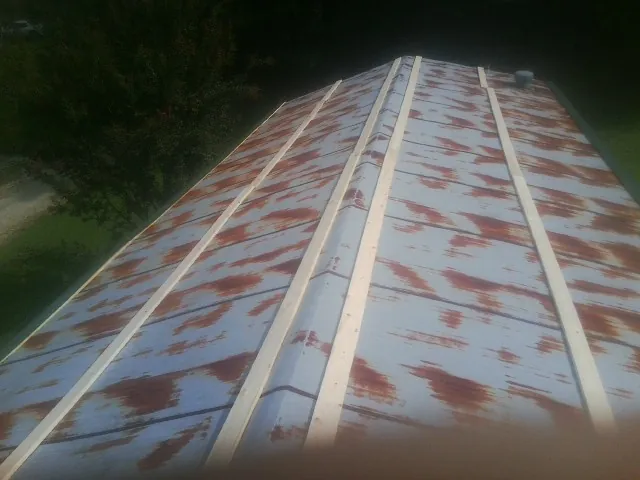 Rusted metal roof panels with new wood purlins before replacement — Storm Damage Roof Repair in Meridale by Roofing Brothers